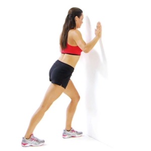 Stretching Exercises Stand facing a wall at about arm's length away. Stand with both feet facing straight ahead - parallel - not turned out, even a small amount. Put one foot on the wall at knee height.