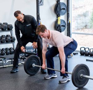 Doctor of Physical Therapy working with a client in Raleigh on sports strength training