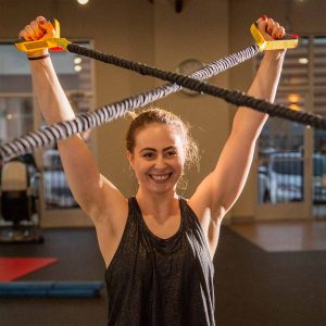 a woman is stretching her shoulders
